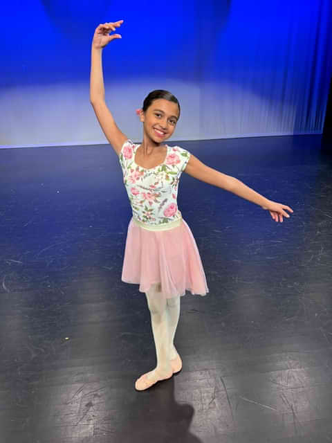 A Young Ballet Student Posing On Stage